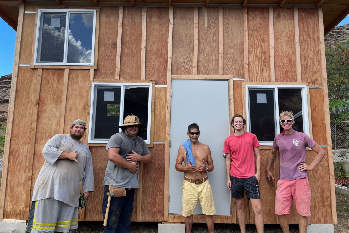 Ryan Routh (first right) with his son (next to Ryan) and workers at his construction company, 2021.