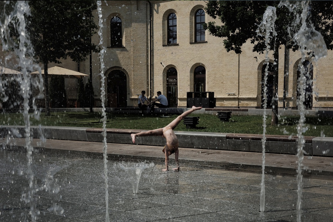 Children play in the fountain near Arsenalna underground station.