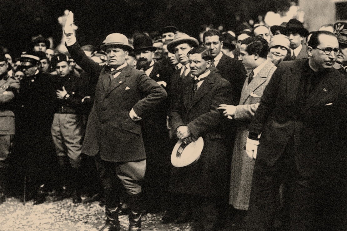 Беніто Муссоліні (у центрі з піднятою рукою) серед членів фашистської партії, 1922 рік.