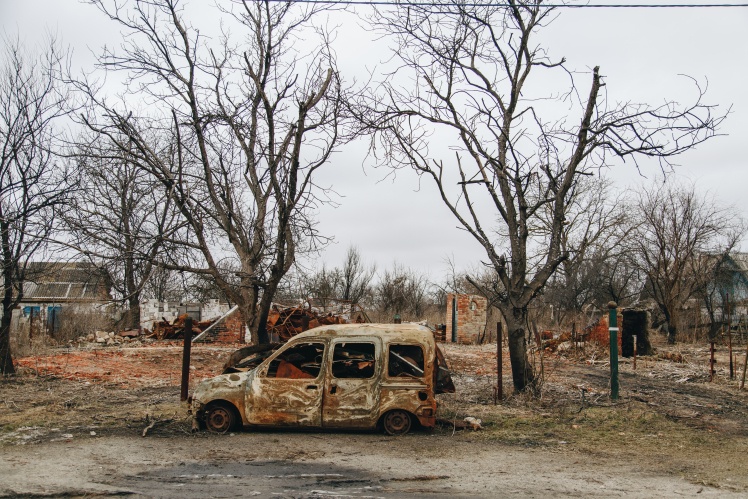 In the village, there are still burnt cars on the streets.