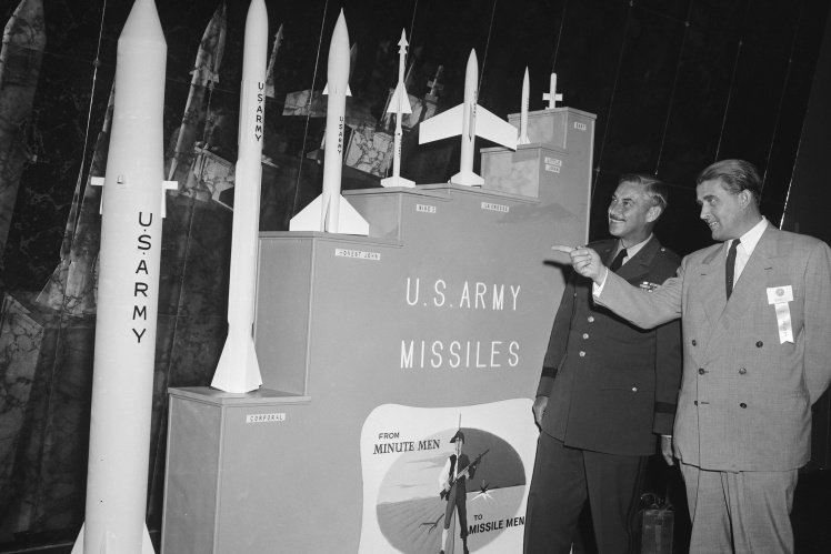 Wernher von Braun (right) shows mock-ups of American ballistic missiles developed under his leadership on October 27, 1956.