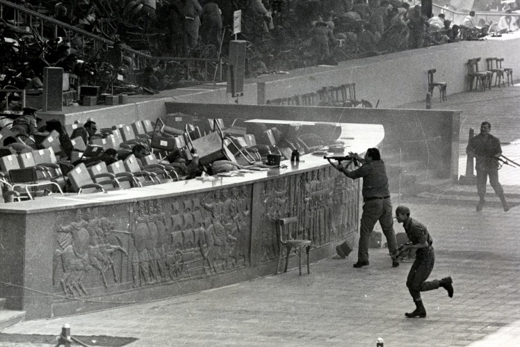 Attackers fire on the government tribune, where Anwar Sadat was present, during a military parade in Cairo, October 6, 1981.