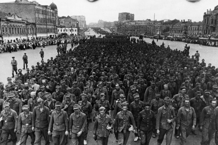 German soldiers captured on the Eastern Front are escorted by Soviet troops, July 1944.