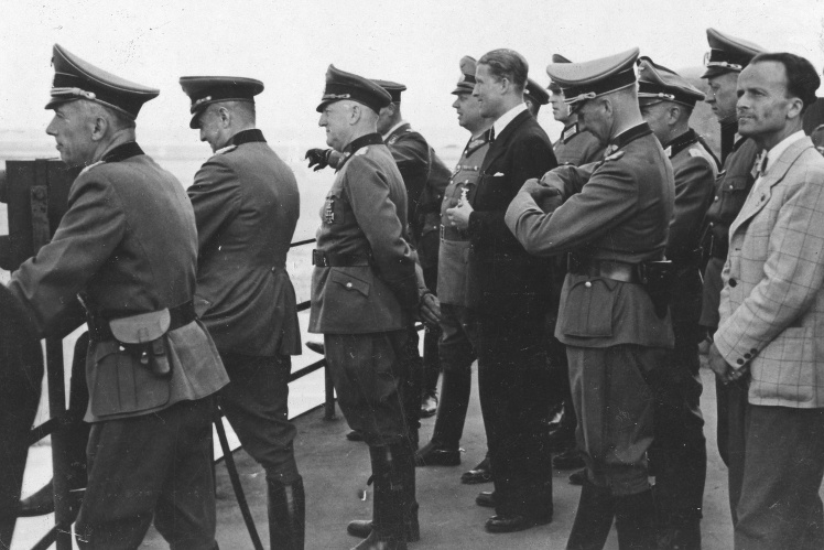 Wernher von Braun (in suit, center) with Nazi generals during missile tests, 1940s.