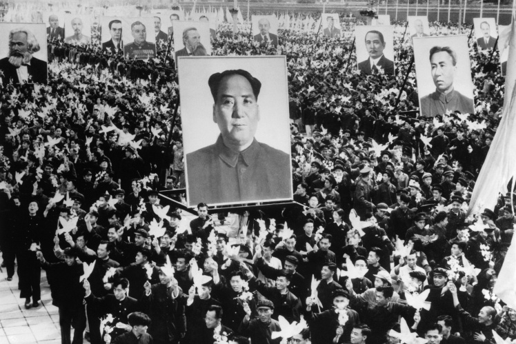 Participants in a Communist parade in Beijing, with a portrait of Mao Zedong in the foreground, 1955.