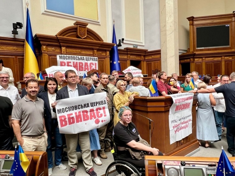 Deputies with placards block the tribune in the Rada.