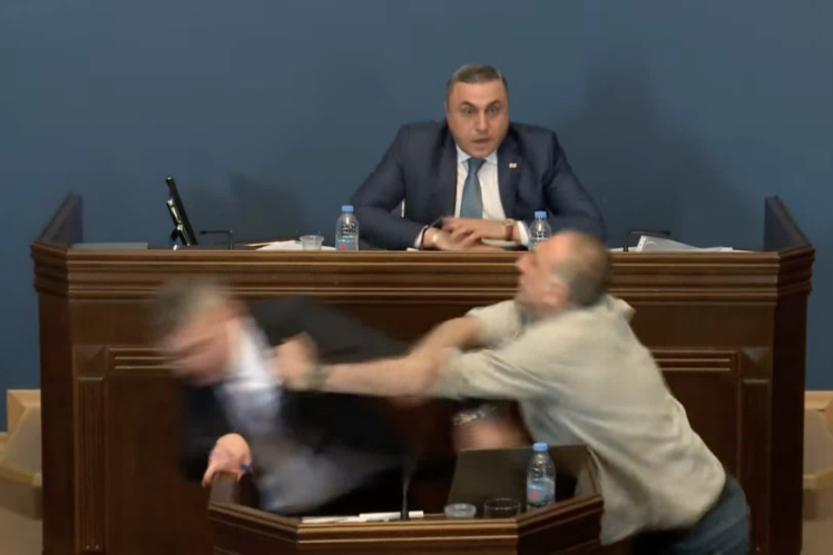 Opposition MP Aleko Elisashvili punches Mamuka Mdinaradze, leader of the ruling Georgian Dream party, during a speech at a parliamentary debate on the draft law on foreign agents, Tbilisi, April 15, 2024.