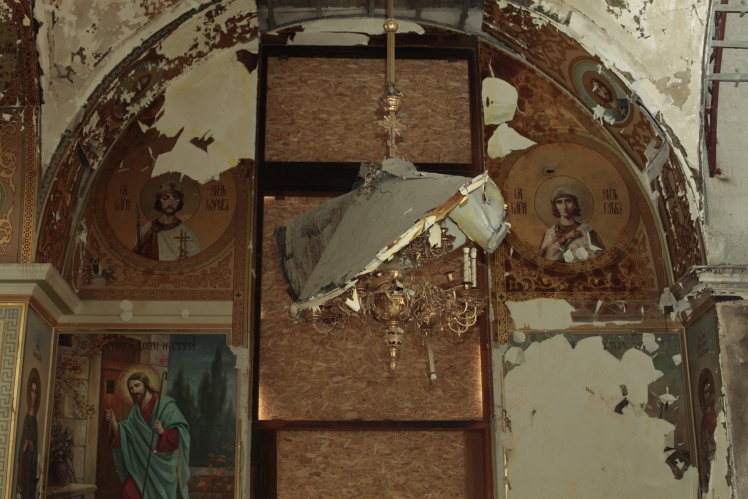 Icons and a chandelier damaged by debris.