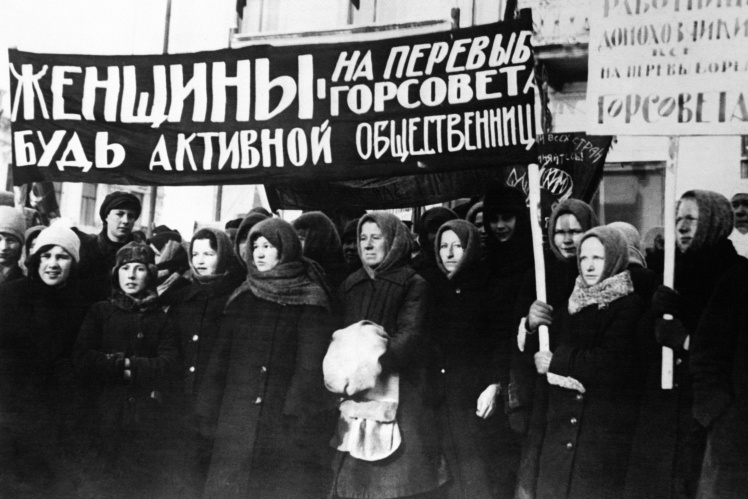 Rally on the occasion of International Womenʼs Day, Moscow, 1950s. "Women, rush for reelections to the city council!", reads the sign.