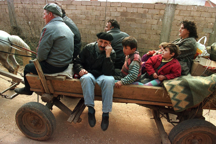 Kosovars return to their village on March 29, 1998, four weeks after an attack by Serbian paramilitary forces.