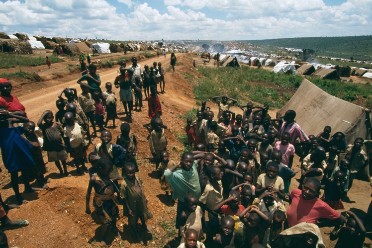 Hutu refugees stand by a dirt road in the Maza refugee camp in southern Rwanda.