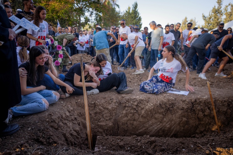 Family and friends are burying three members of the Sharabi family in southern Israel.