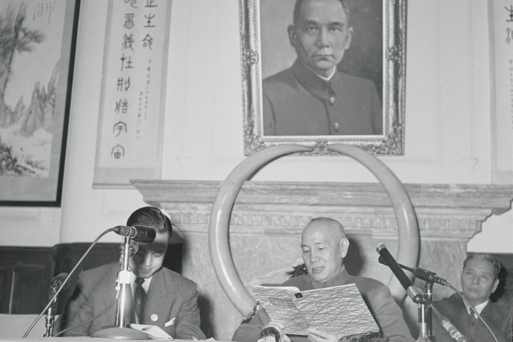 Chiang Kai-shek, seated under a portrait of Sun Yat-sen, confirms that the United States will provide aid in the event of a communist invasion of Taiwan, 1955.