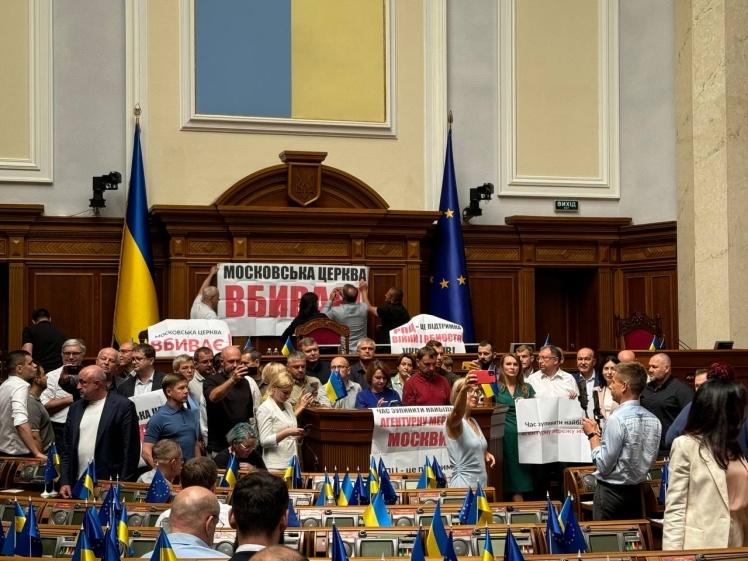 Deputies with placards block the tribune in the Rada.