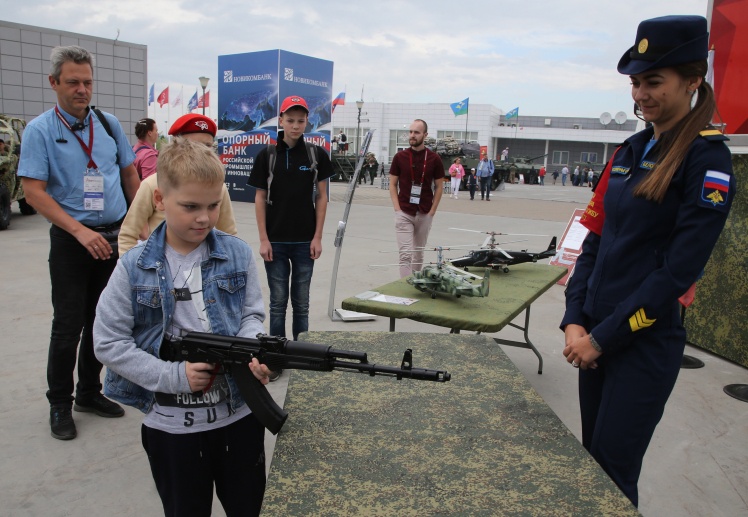 A boy examines a Kalashnikov AK-74 assault rifle while visiting an exhibition at the Army 2022 forum, on August 20, 2022, in Patriot Park near Moscow, Russia.