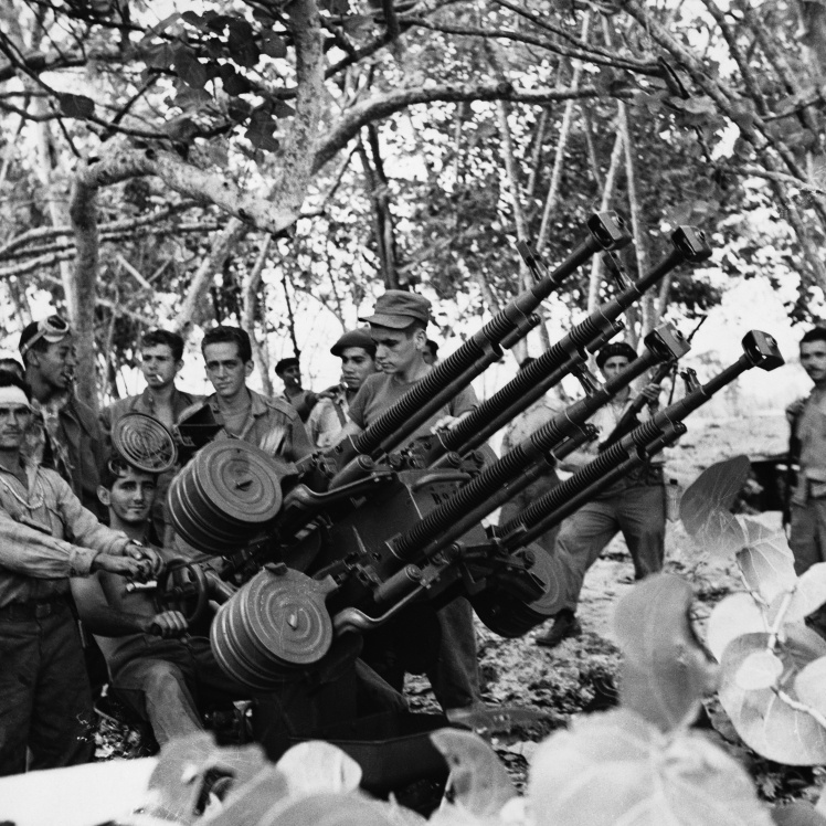 Cuban government troops near an anti-aircraft machine gun repelling the Bay of Pigs invasion, April 1961.
