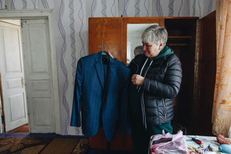 Vadymʼs mother shows the suit that her son bought for the wedding.