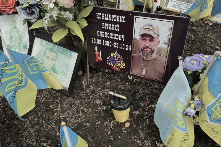 The soldiers leave coffee and cigarettes for their dead comrades.