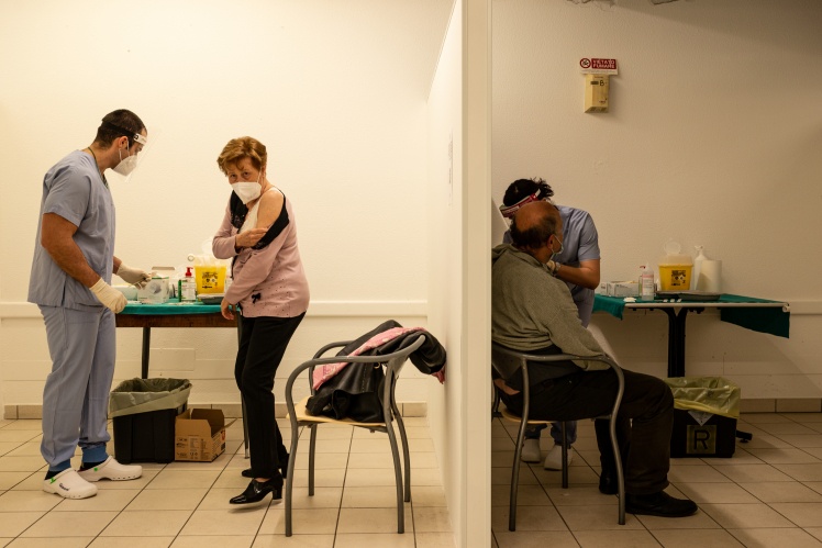 Nurses prepare to administer the "Sputnik V" vaccine to elderly people at a public hospital in San Marino, Italy, April 8, 2021.