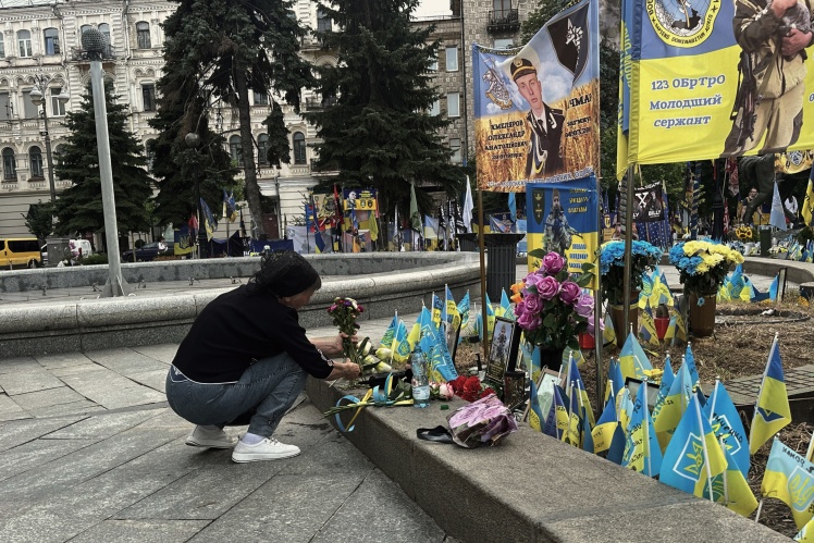 The mother brings flowers to her son every week. She covered the area with stones and placed several photos and a banner on it. The man died in the Kursk region.