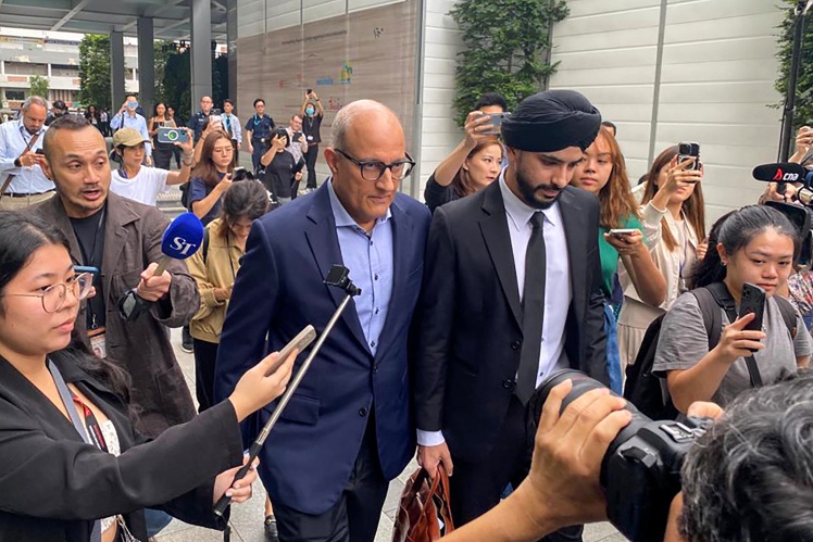 Minister Iswaran (center right) leaves the courthouse after one of the hearings in the corruption case against him, January 2024.
