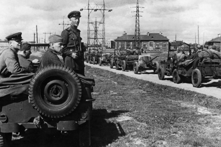 The commander of the Soviet anti-tank battalion watches a convoy of American jeeps sent on a lend-lease program, 1943-1945.