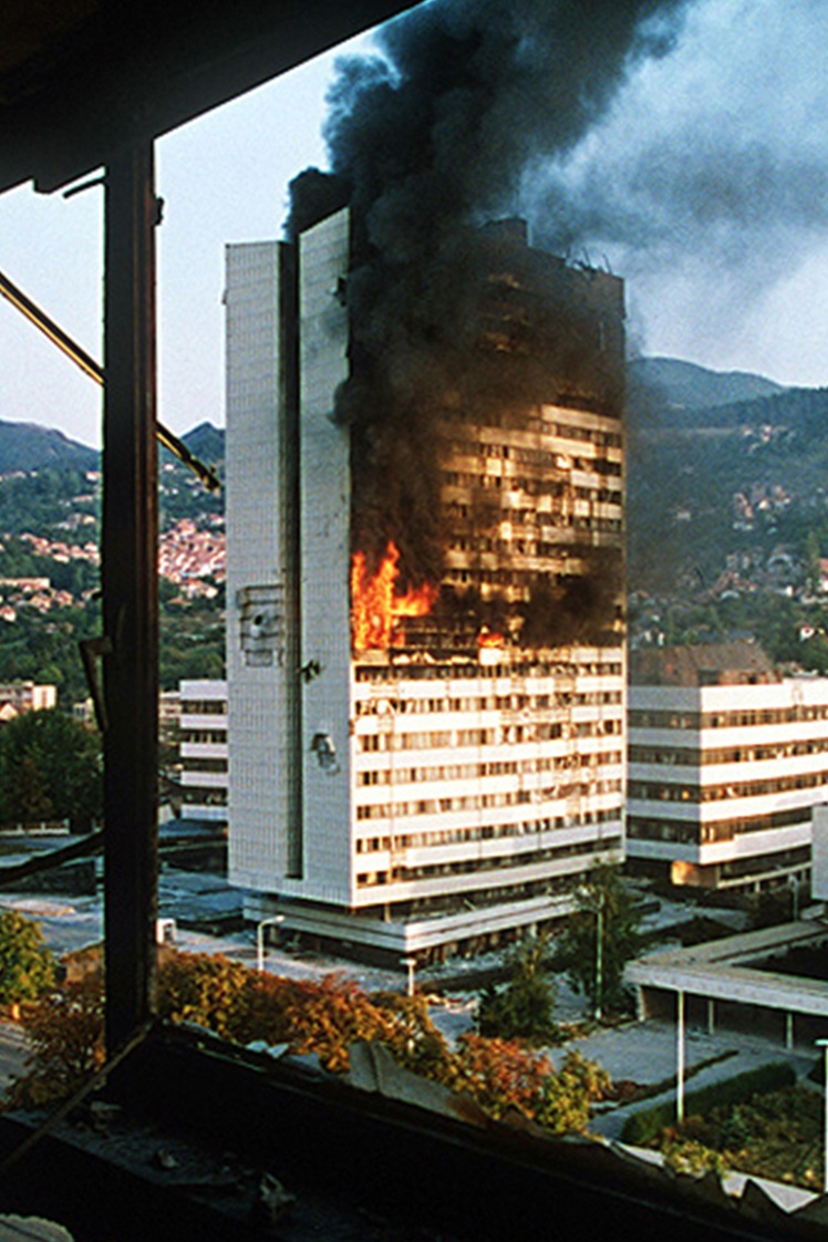 A government building in central Sarajevo burns after being hit by a tank during a siege in 1992.