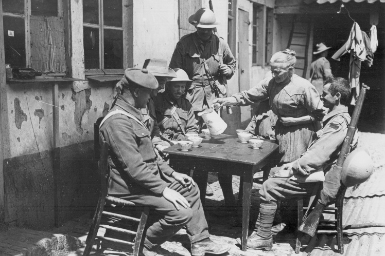 A French woman pours coffee for British soldiers, May 1916.