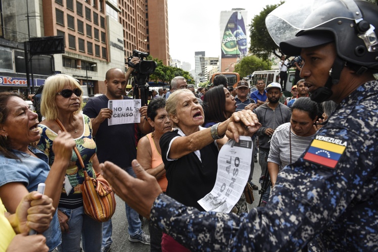 Демонстранты протестуют против переписи транспортных средств для получения талонов на бензин по госценам в Каракасе, 3 августа 2018 года.