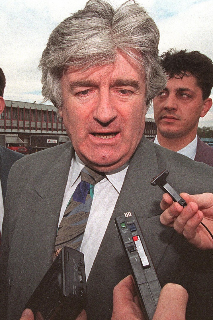 Bosnian Serb leader Radovan Karadzic flanked by bodyguards arriving for a private visit at Moscow airport.