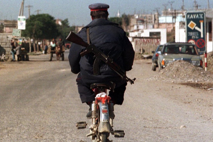 Полицейский на мопеде в городе Кавая в центральной Албании, в 60 километрах от Тираны, 4 марта 1997 года.